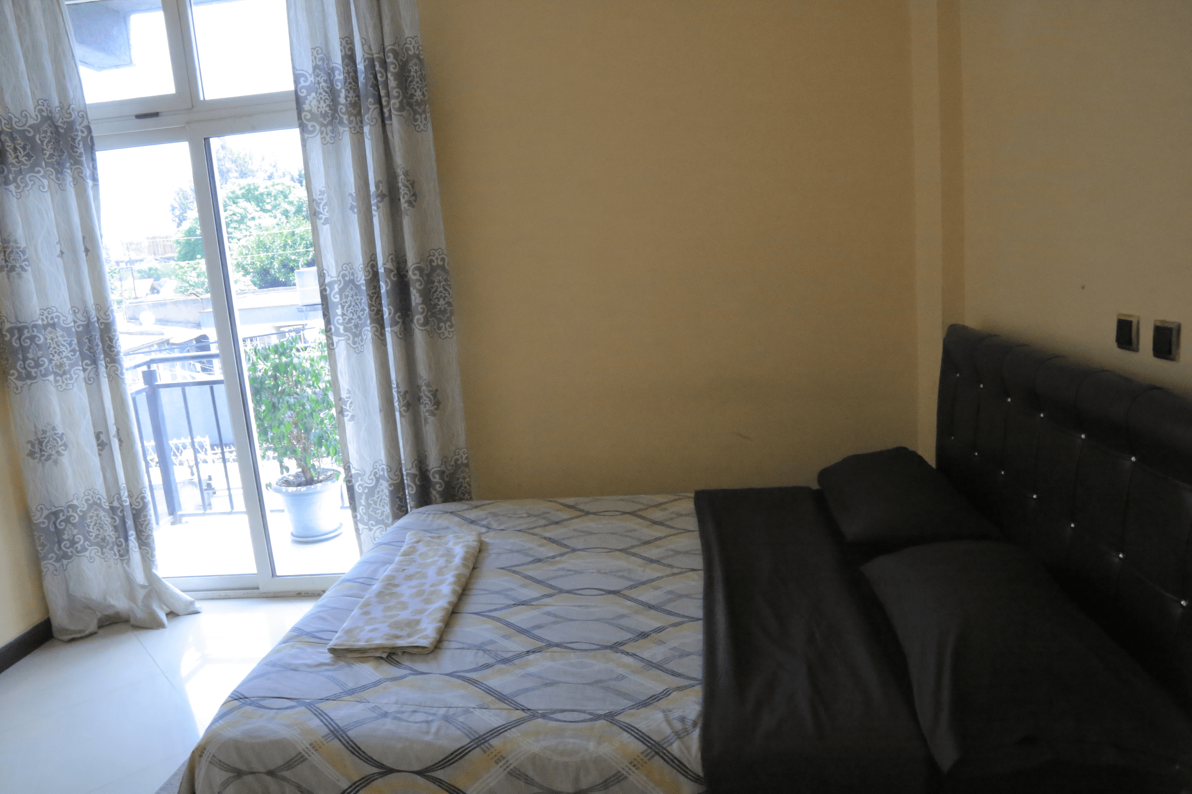 Interior of a cozy 1 bedroom with a queen bed and private bathroom in liyat guest house